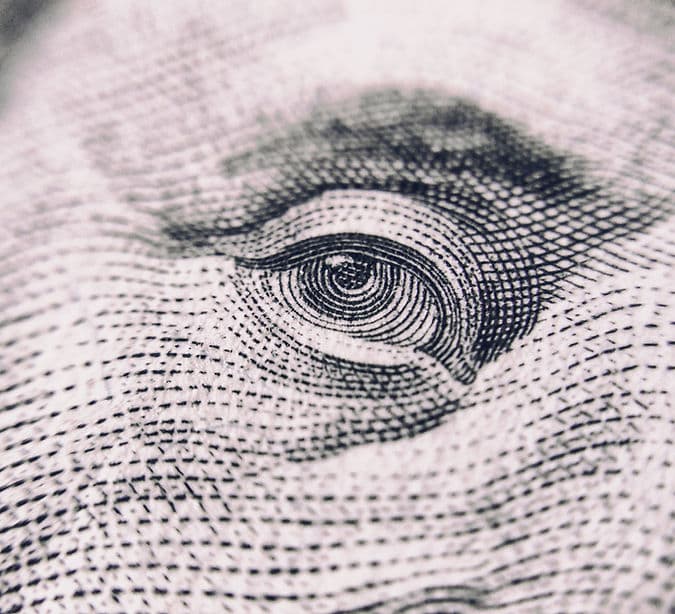 Engraving of an eye symbolizing financial insight